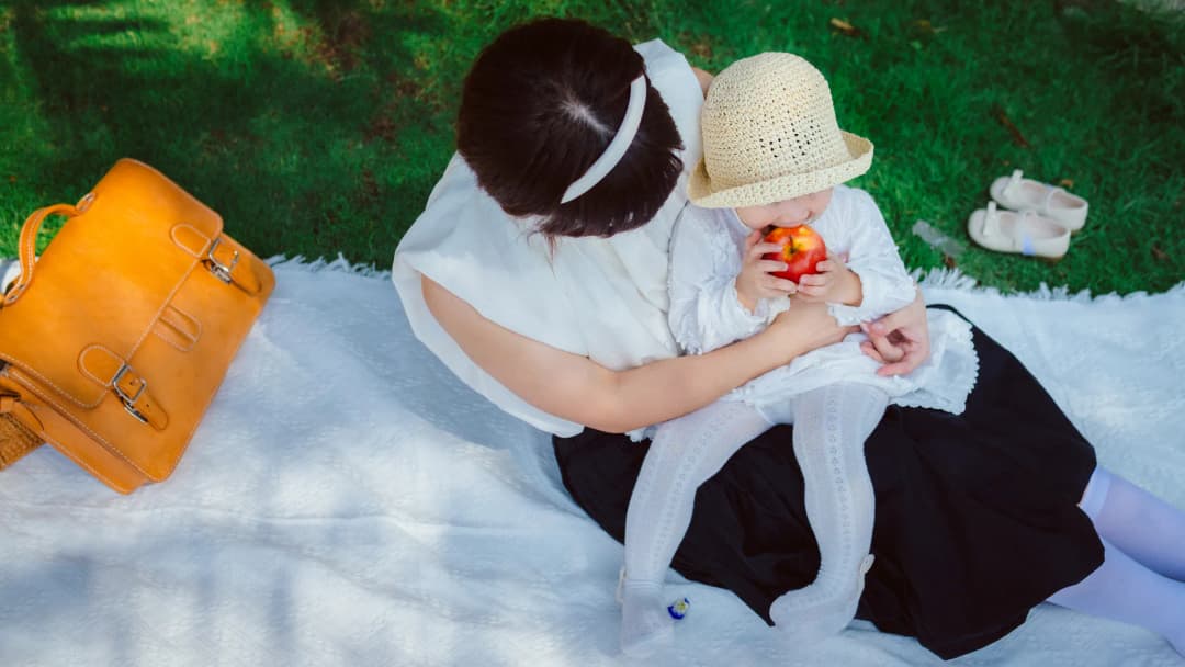 Parents holding their baby outdoors
