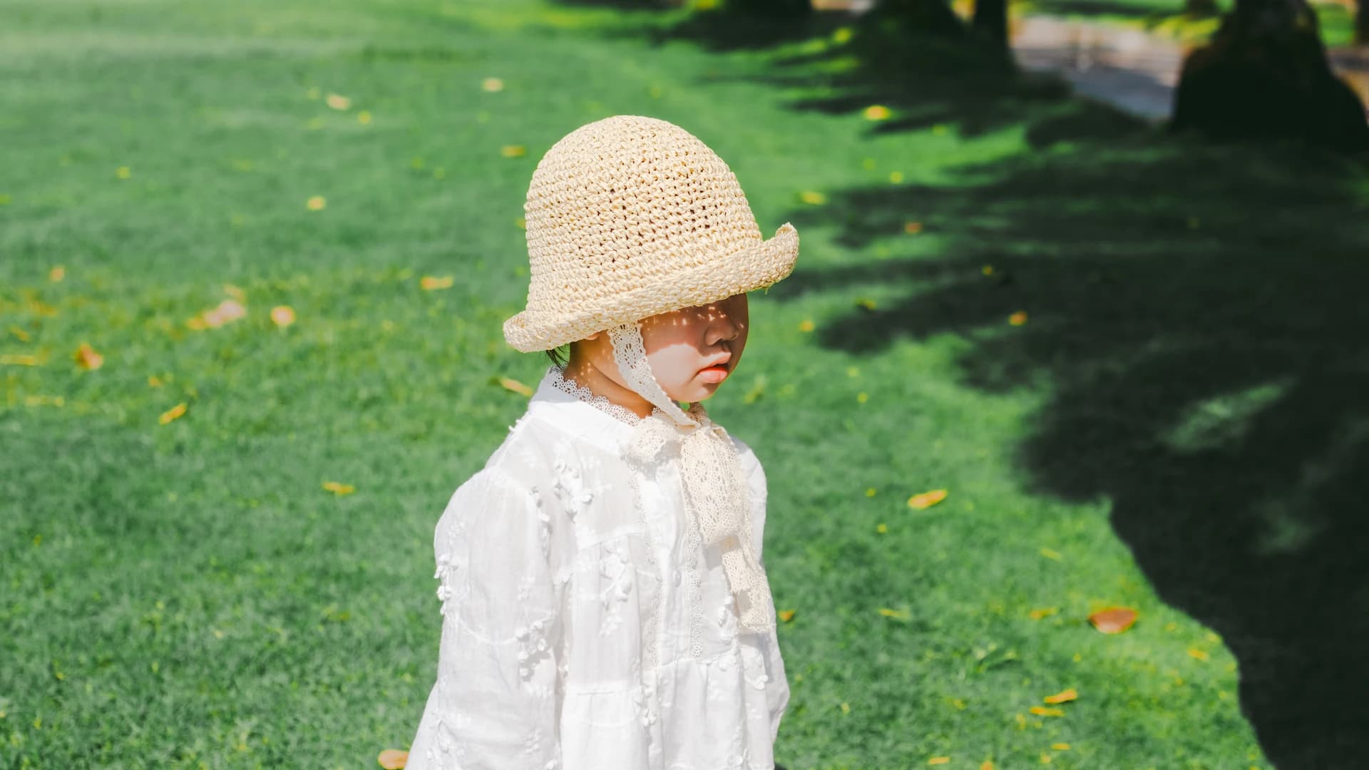 Toddler in yellow hat outdoor portrait in Saigon by Kevin Duong
