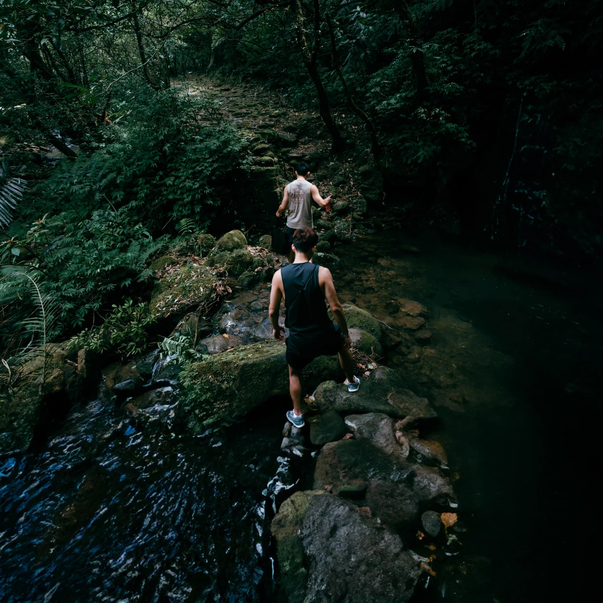Travelers exploring a waterfall stream in Vietnam, photographed by Kevin Duong