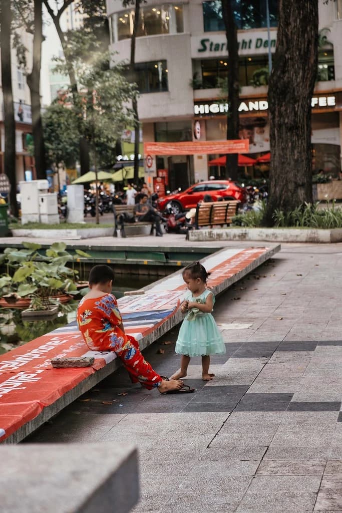 Candid street moment in Ho Chi Minh City with children playing