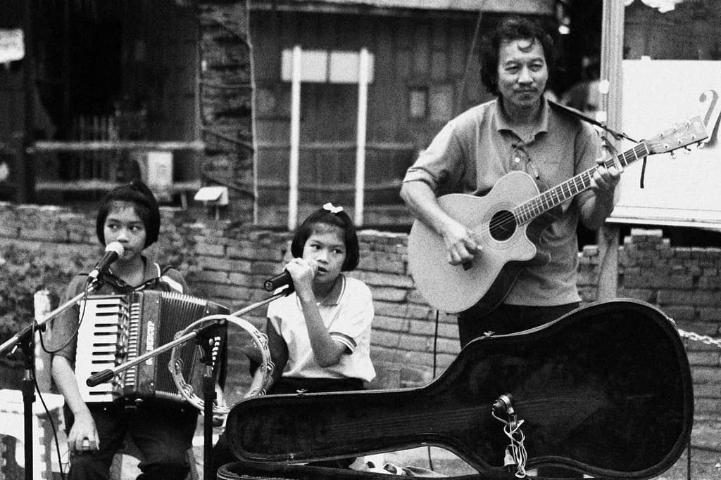 Street musicians performing in black and white tone in Saigon